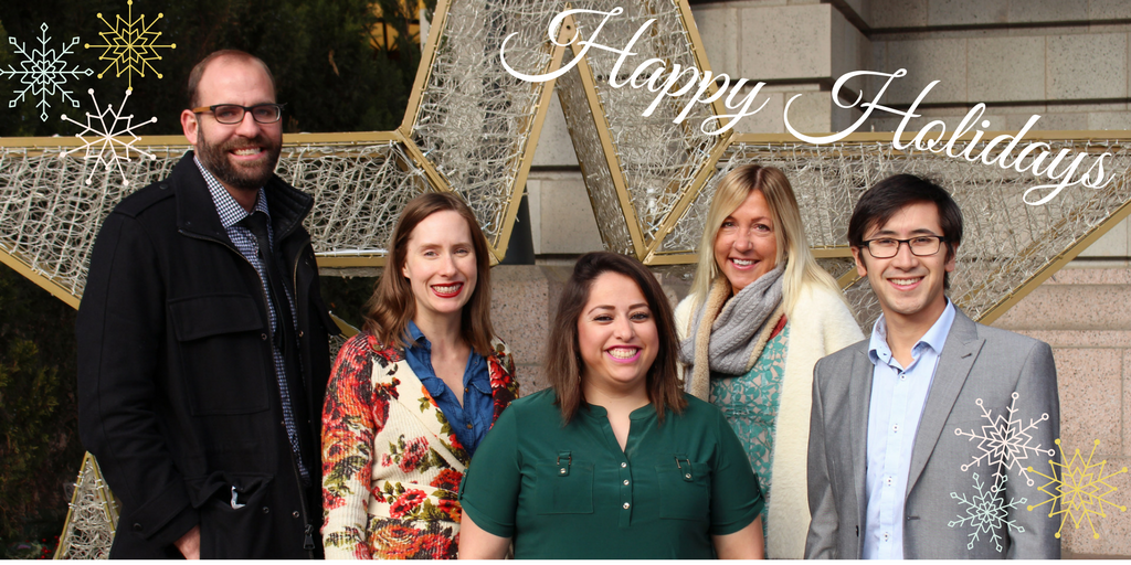 Image of the CVSuite team, from left to right: Adam Sestokas, Erica Antioco Barclay, Natalie Villa, Susan Gillespie and Paul Nguyen standing infront of a holiday star. 