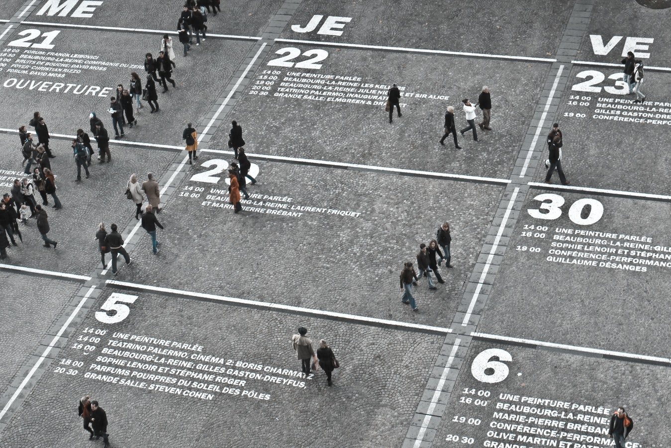 Aerial shot of people walking across a street that looks like a calendar