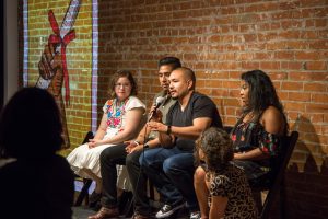 brown background with a group of people talking