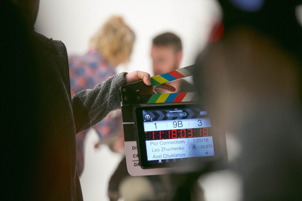 A group of people in a room getting ready to shoot a film.